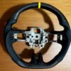 Ford mustang carbon fiber steering wheels with yellow accents.